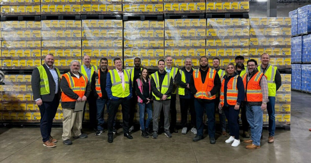 Odyssey team members standing together in a warehouse